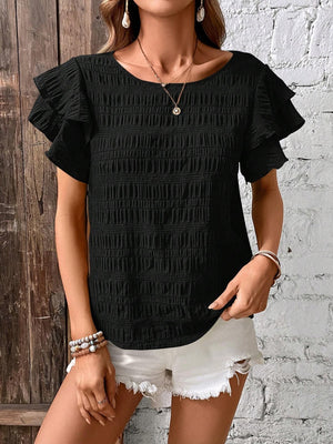 Black textured smocked blouse with ruffle sleeves and round neckline.