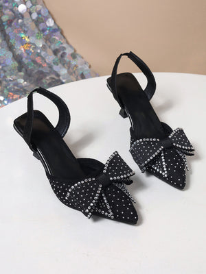 Black slingback heels with rhinestone bowknot detail.