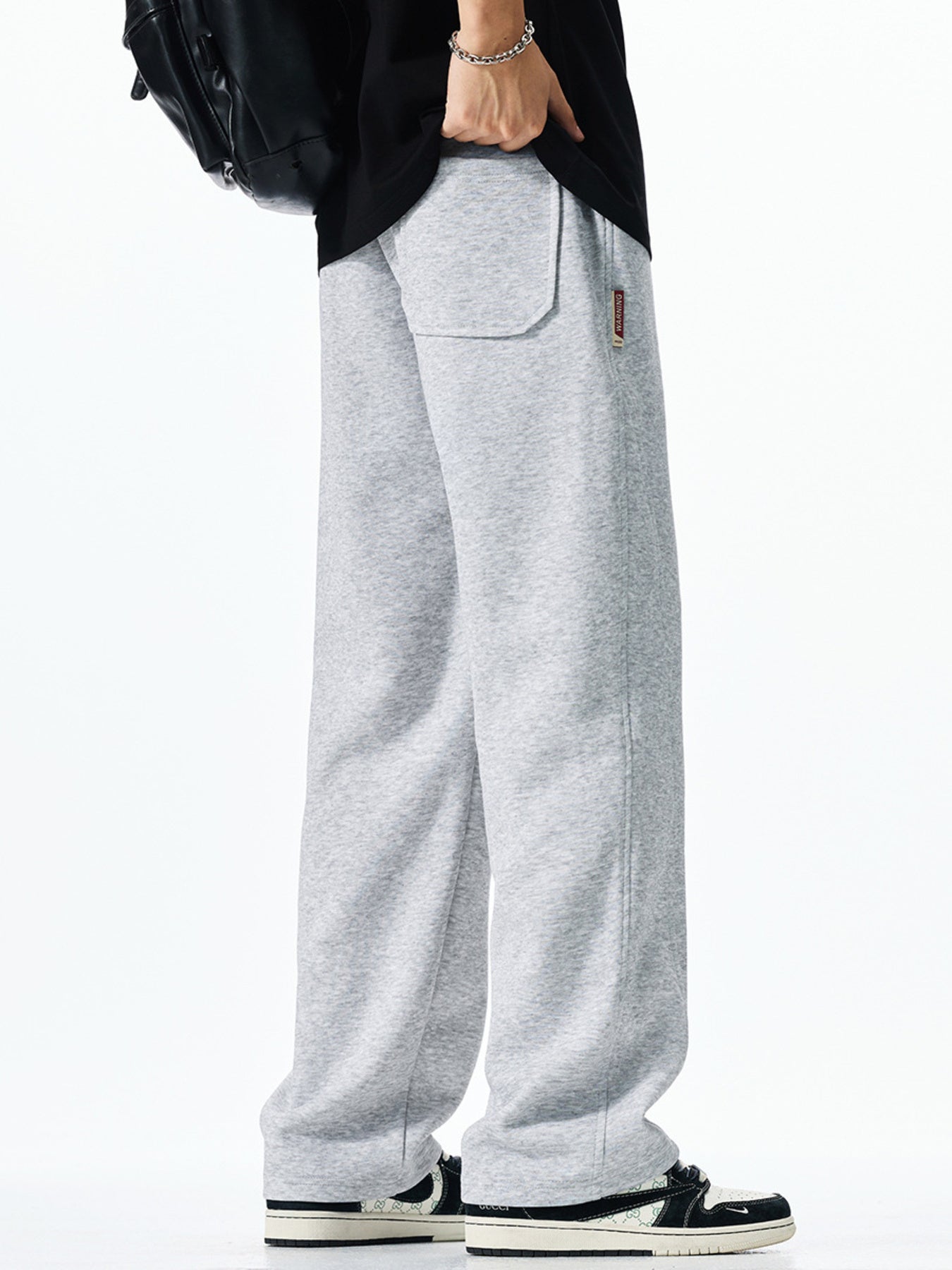 Men's light grey casual drawstring sweatpants with loose fit and back pocket detail.