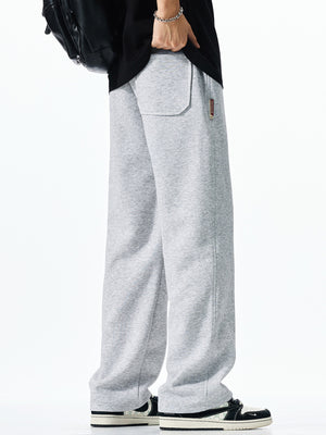 Men's light grey casual drawstring sweatpants with loose fit and back pocket detail.