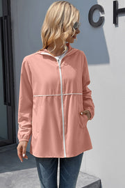Blush pink hooded rain coat with white zipper and trim, full zip, pockets
