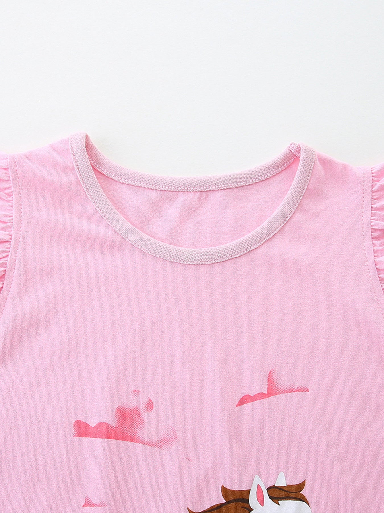 Girls' pink cotton tank top with galloping horse graphic and ruffled sleeves.