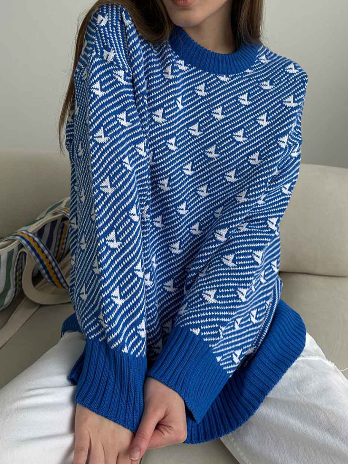 Royal blue knit sweater with white sailboat pattern, crew neck, ribbed cuffs and hem.