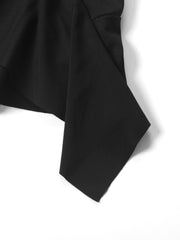Black asymmetrical ruched mini dress detail showing dynamic silhouette and fabric texture.