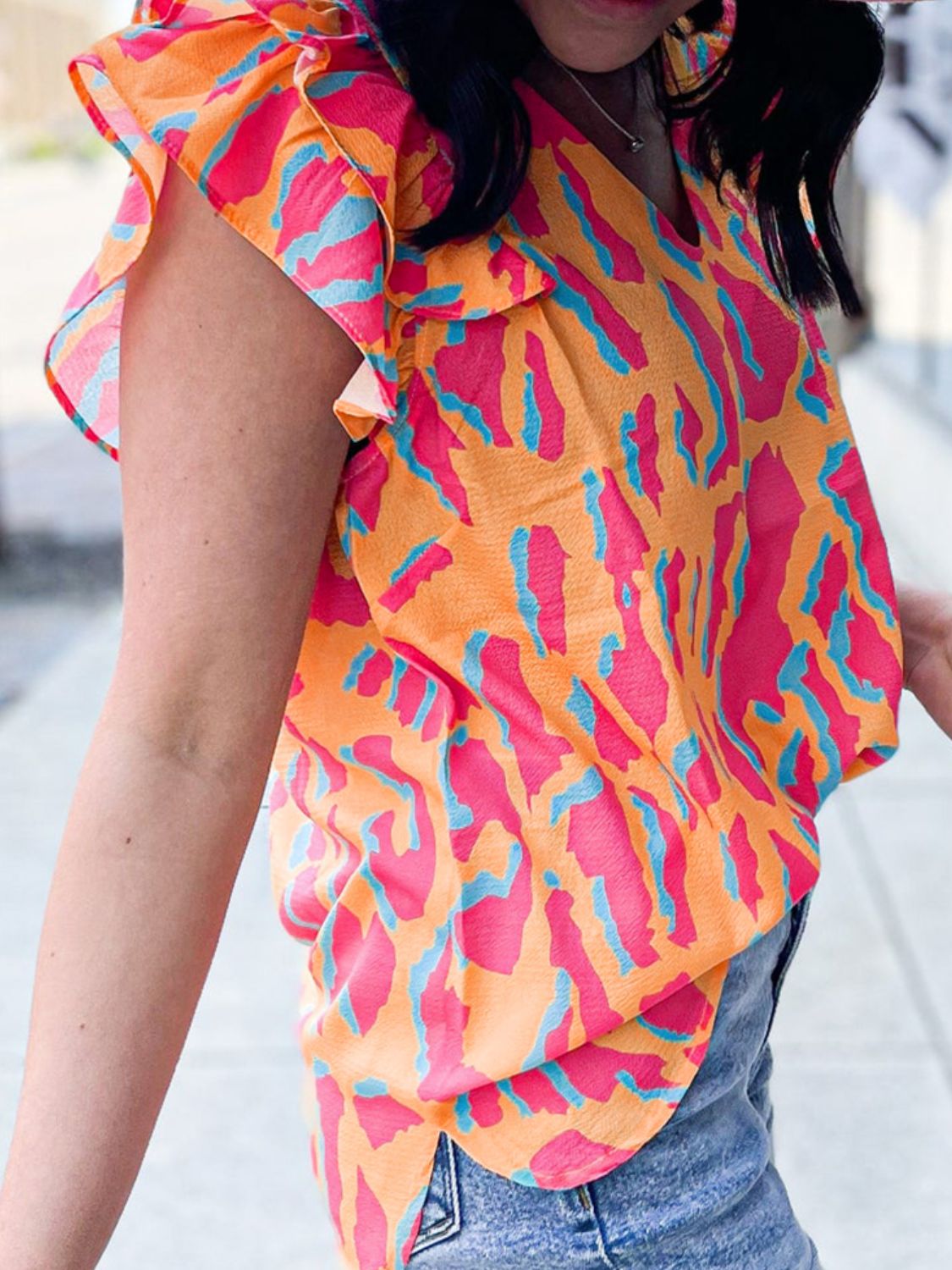 Neon abstract ruffle sleeve blouse in multicolor with a V-neck.