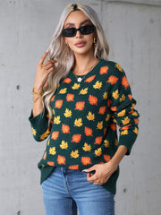 Dark green acrylic knit crewneck sweater with all-over orange and yellow autumnal leaf motif.