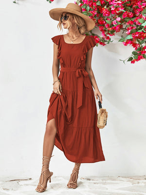 Belted midi dress in brick red with flutter sleeves and tiered skirt.