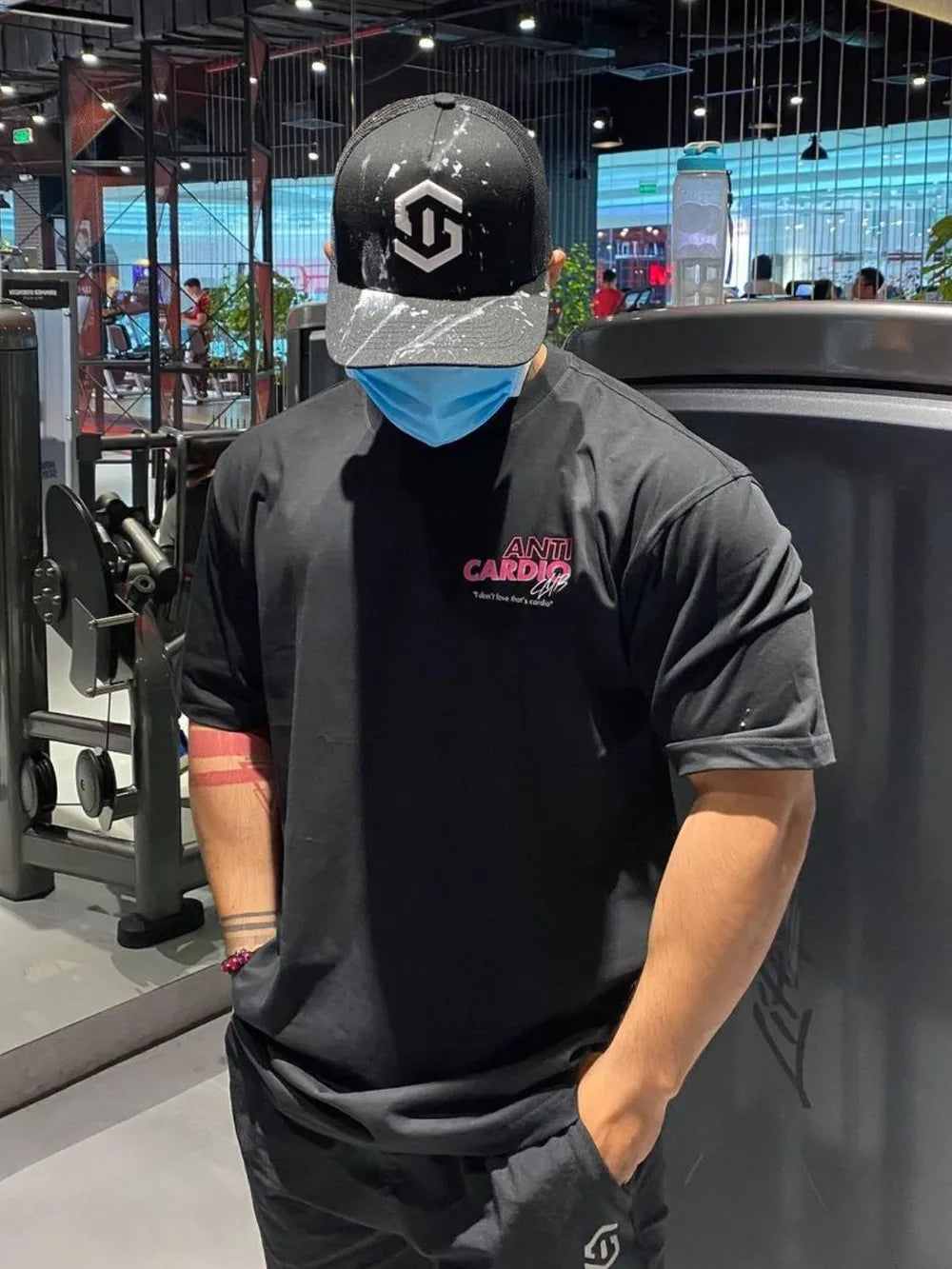 Black graphic t-shirt with pink "Anti Cardio Club" text and a small white tagline.