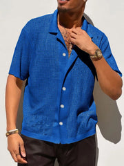 Royal blue perforated knit resort shirt with short sleeves and a button-up front.