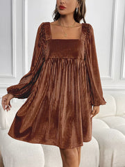 Brown velvet mini dress with square neckline, long sleeves, and pleated texture.