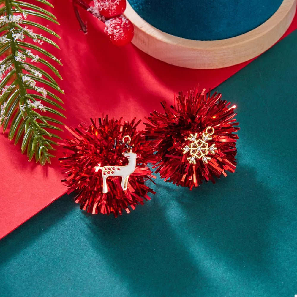 Red tinsel ball earrings with reindeer and snowflake charms, 18k gold accents.