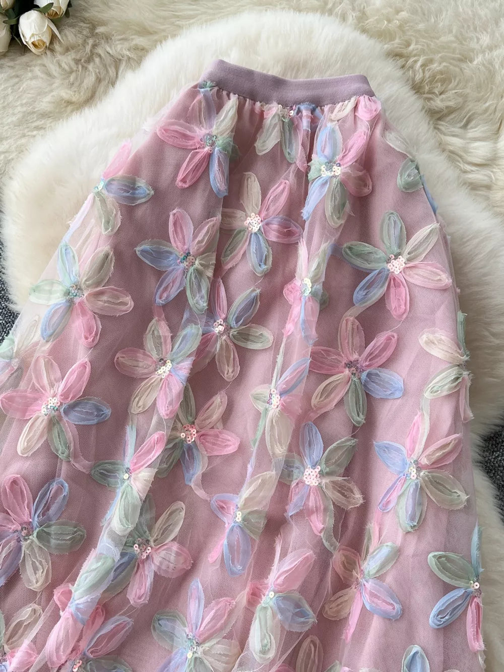 Layered floral skirt in pink with pastel embroidered flowers and sequins.