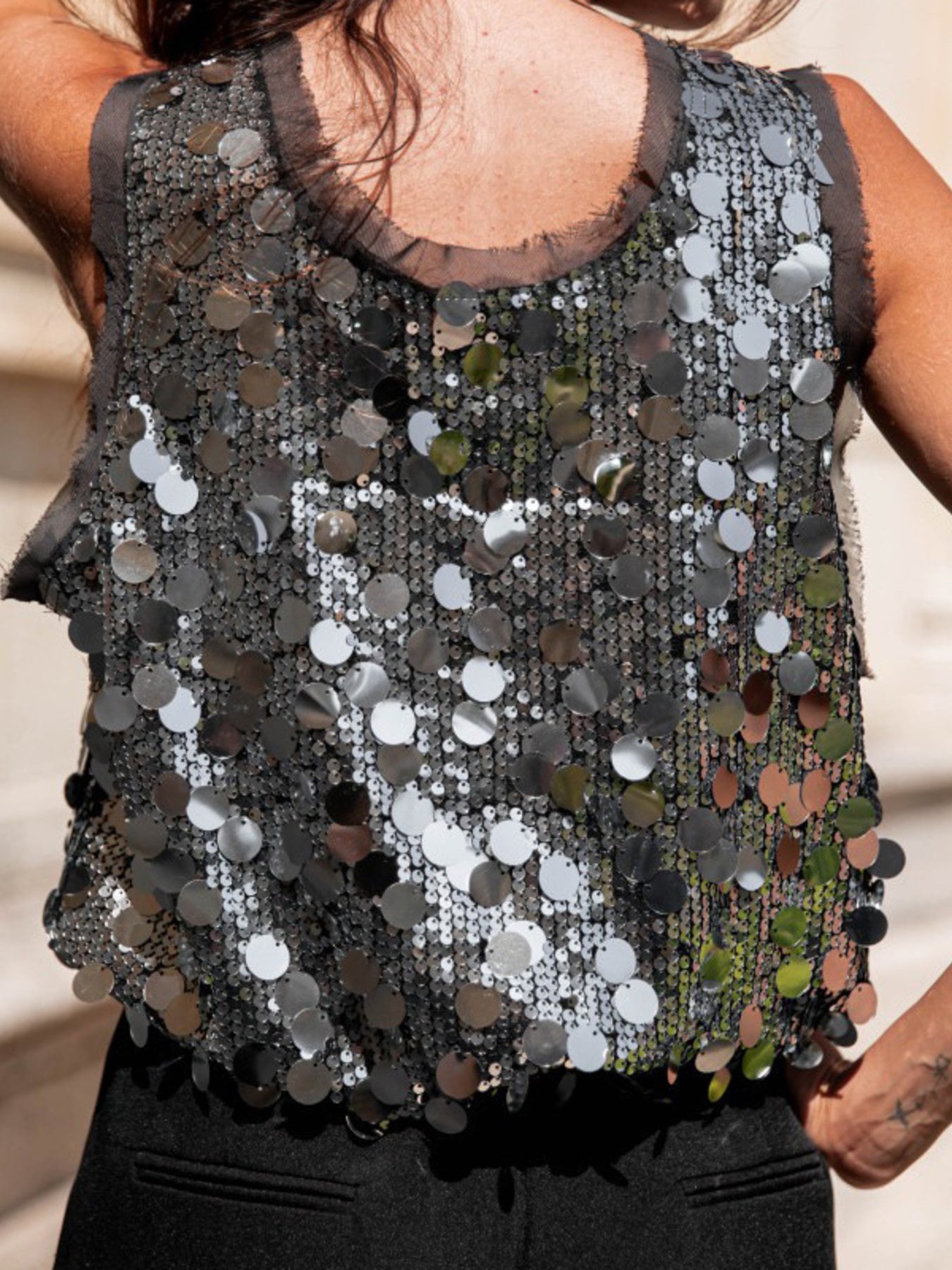 Gray sequin tank top with round neckline and sheer trim, embellished with large circular sequins.