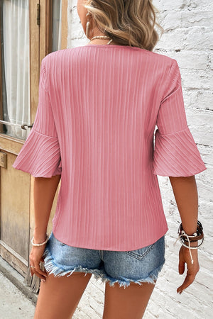 Dusty Pink V-neck blouse with pleated bell sleeves and vertical ribbed texture.