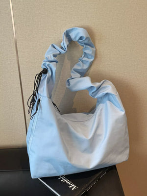 Blue ruched nylon shoulder bag with zipper and drawstring detail