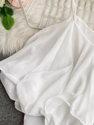 White camisole with delicate ruffles and spaghetti straps.