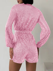 Pink sequin wrap romper with blouson sleeves and cinched waist