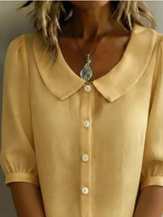 Pastel yellow puff sleeve shirt with Peter Pan collar and button front.