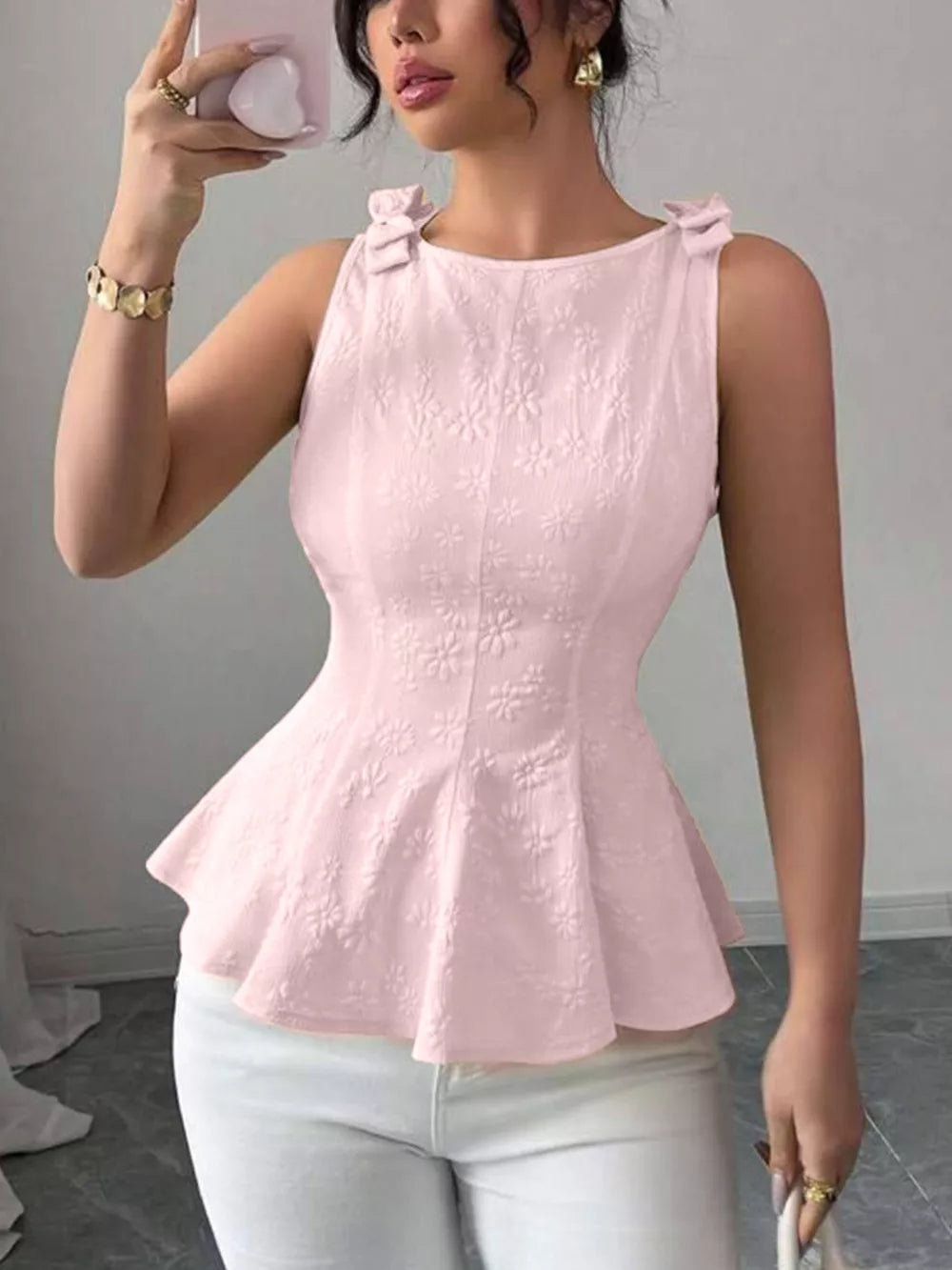 Pink peplum tank top with floral embroidery and bow shoulder details