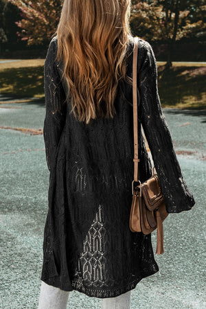 Black openwork maxi cardigan with intricate knit details and bell sleeves.