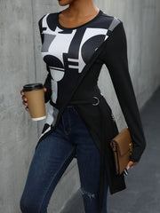 Black tunic with asymmetric geometric print, long sleeves, and belted detail.
