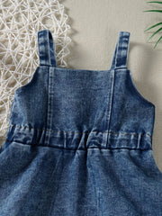 Blue denim overall dress for kids with adjustable straps and elastic waist detail.
