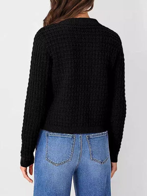 Black textured knit button-up cardigan with a waffle knit pattern and ribbed cuffs.