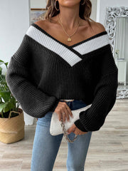 Black off-shoulder knit sweater with white contrast trim and balloon sleeves.