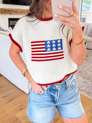 Patriotic knit sweater with American flag design, red trim, and short sleeves.