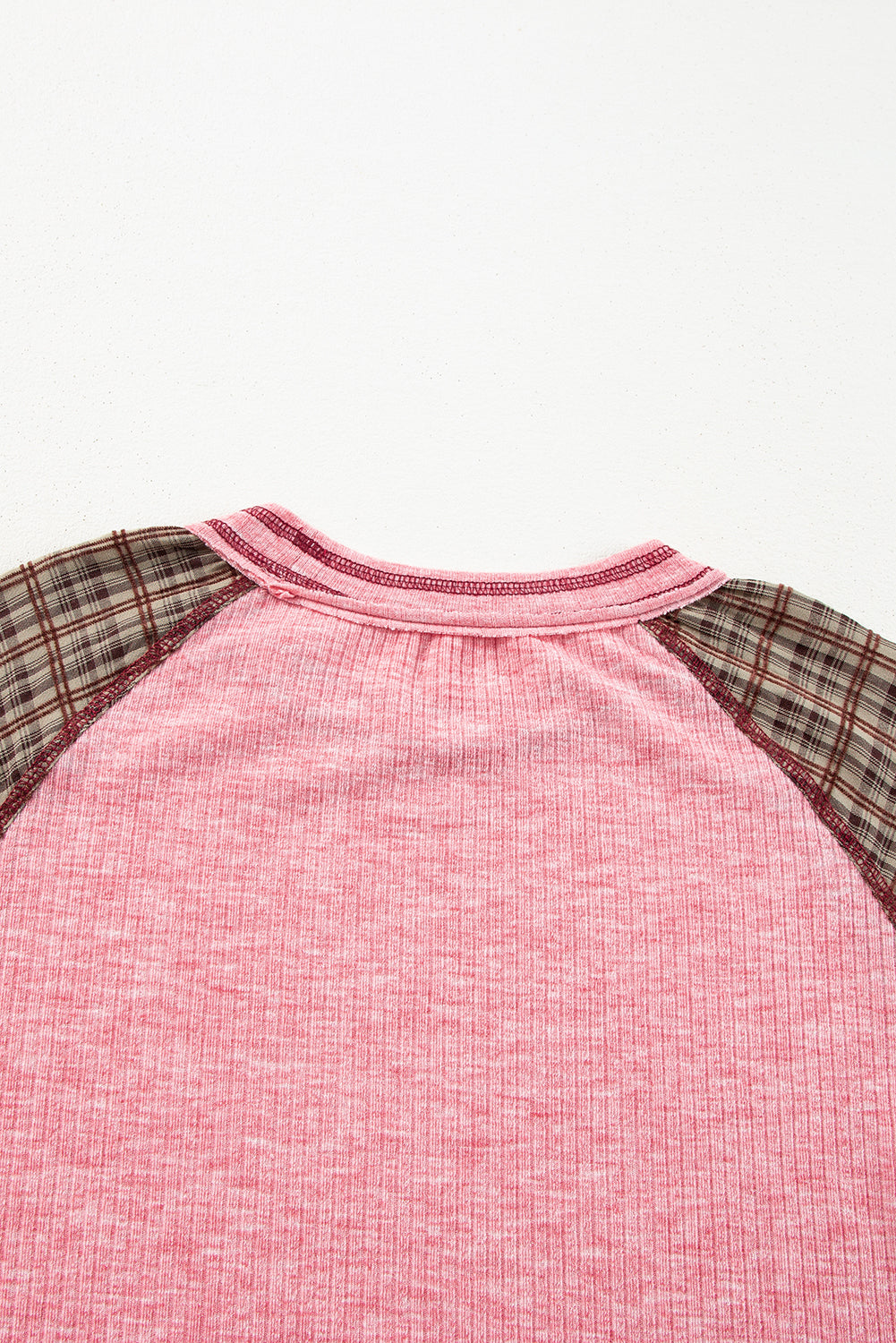 Pink raglan tee with plaid sleeves and a ribbed texture.