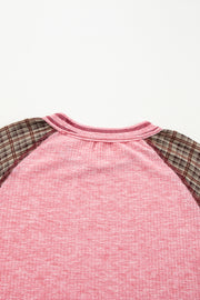 Pink raglan tee with plaid sleeves and a ribbed texture.