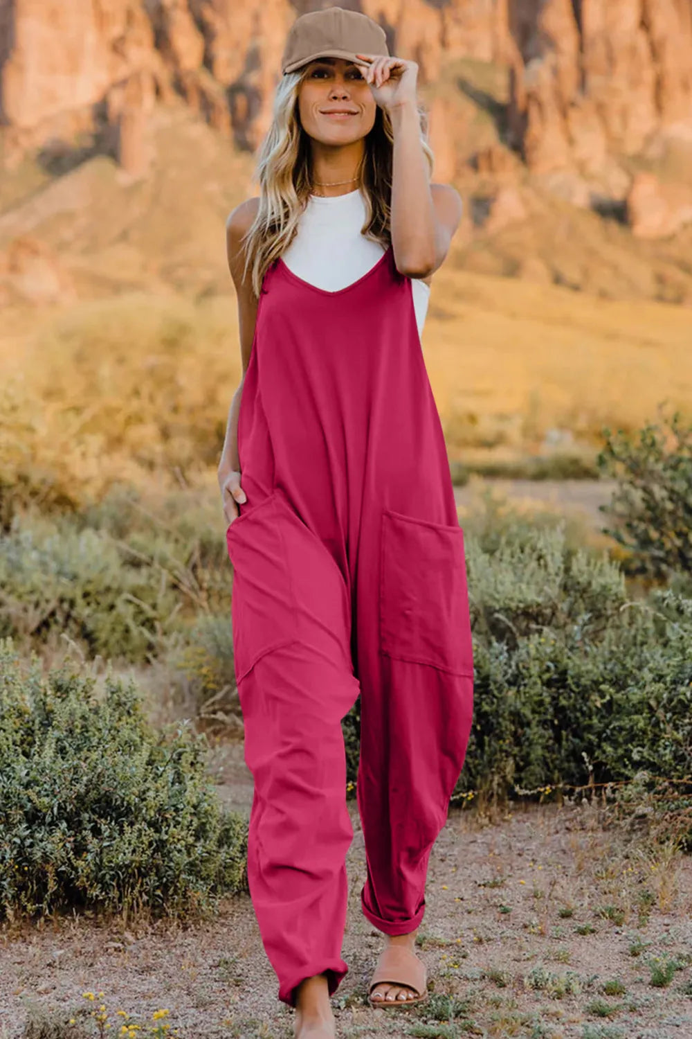 Hot Pink V-neck wide-leg jumpsuit with pockets and adjustable straps.