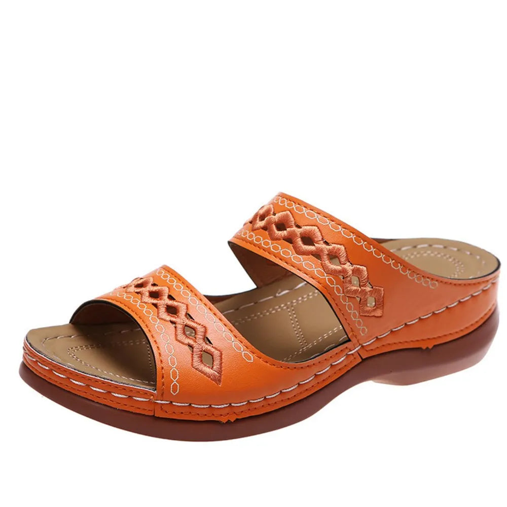 Orange embroidered strap comfort slides with a wedge heel.