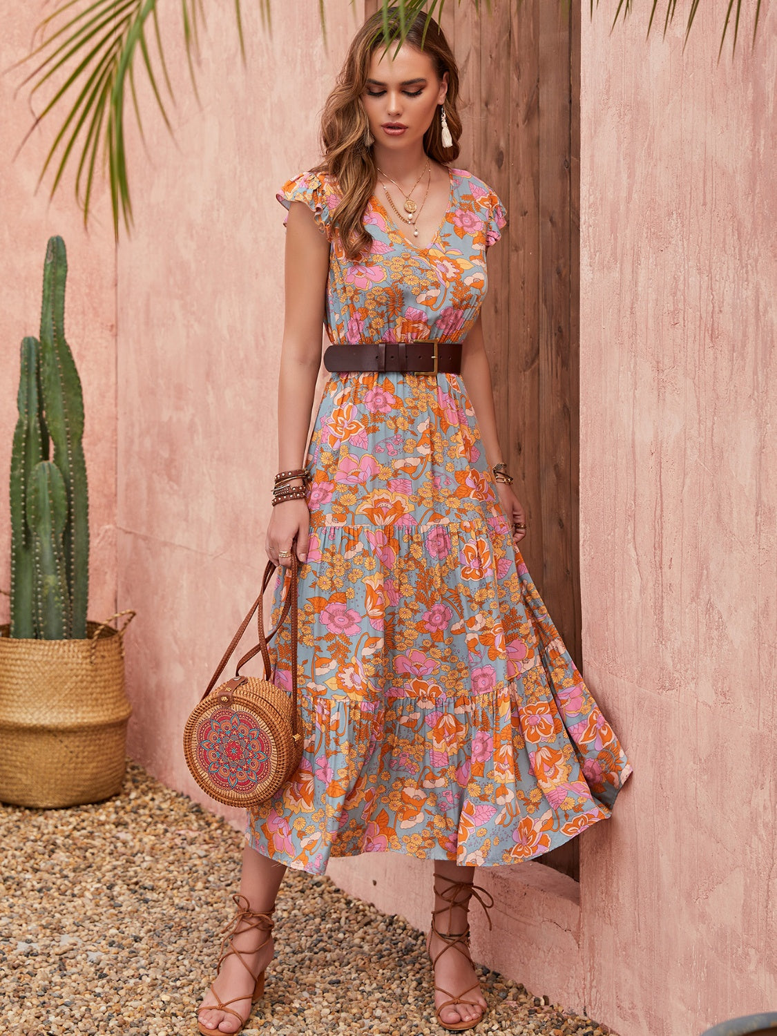Bohemian floral tiered midi dress with flutter sleeves and v-neck in multicolor.