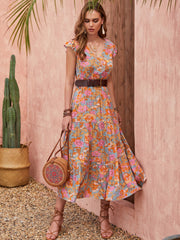 Bohemian floral tiered midi dress with flutter sleeves and v-neck in multicolor.