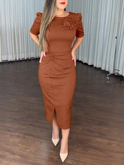 Brown bodycon midi dress with 3D floral detail, ruched waist, and puff sleeves.