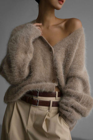 Khaki angora cardigan with sculpted sleeves and button front, styled with a belt.
