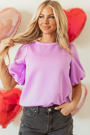 Textured quilted puff sleeve blouse in pink purple with a crew neck.