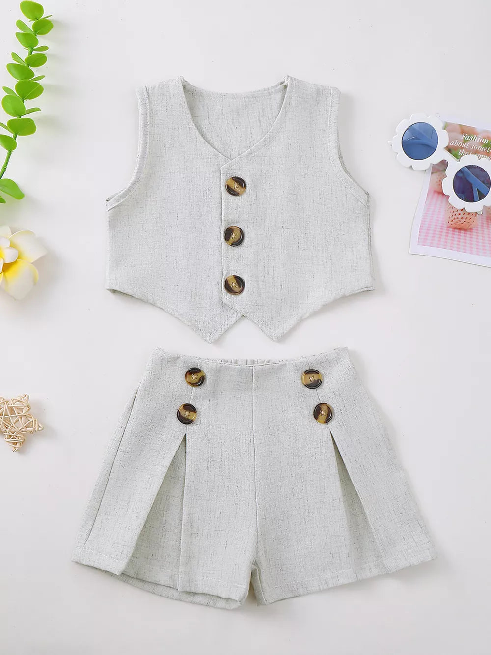 Baby vest and shorts set in light grey textured fabric with decorative buttons.