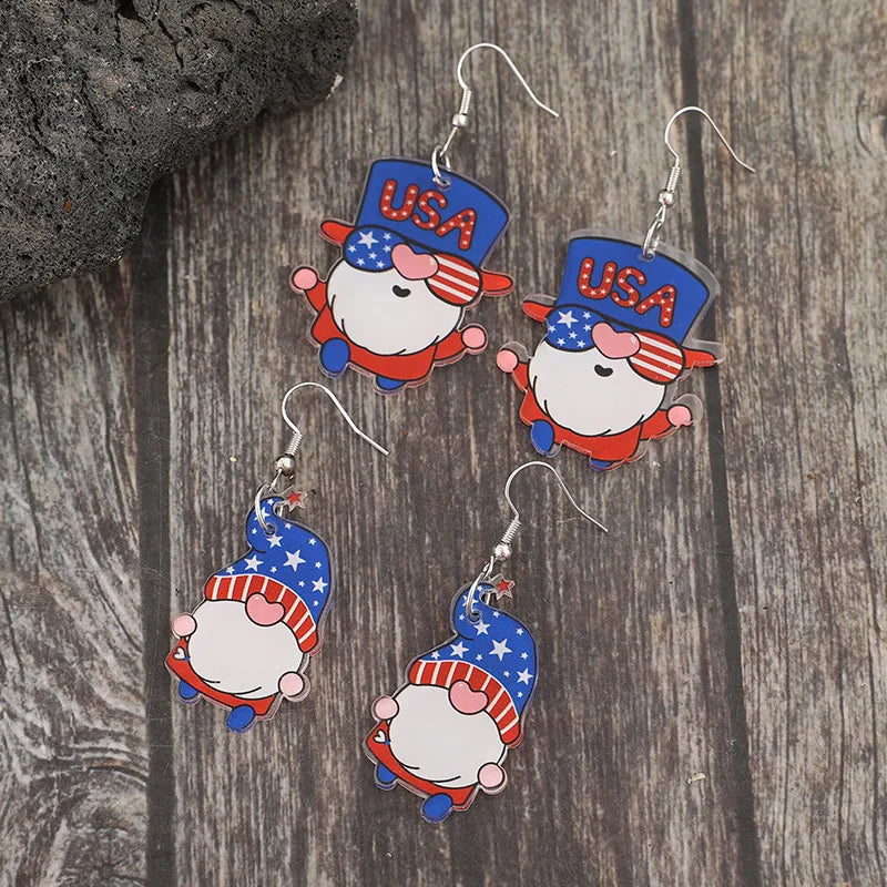 Patriotic gnome drop earrings in royal blue acrylic with USA and star patterns.
