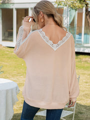 Apricot waffle knit v-neck blouse with white lace trim on neckline and sleeves.