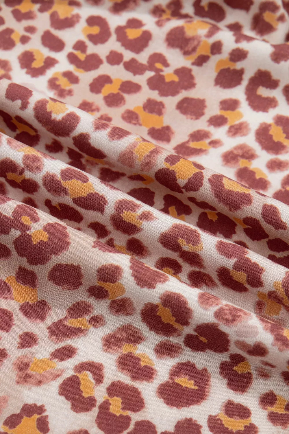 Leopard print dress fabric with ruffled detail and v-neck detail