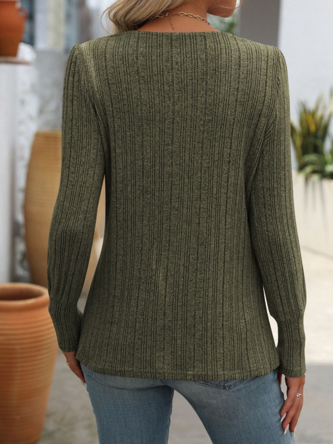 Army green ribbed knit top with side button detail, long sleeves.