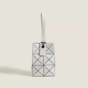 White geometric panel tote bag with a single handle and snap closure.