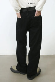 Dark denim trousers with sculpted seams and a relaxed fit.
