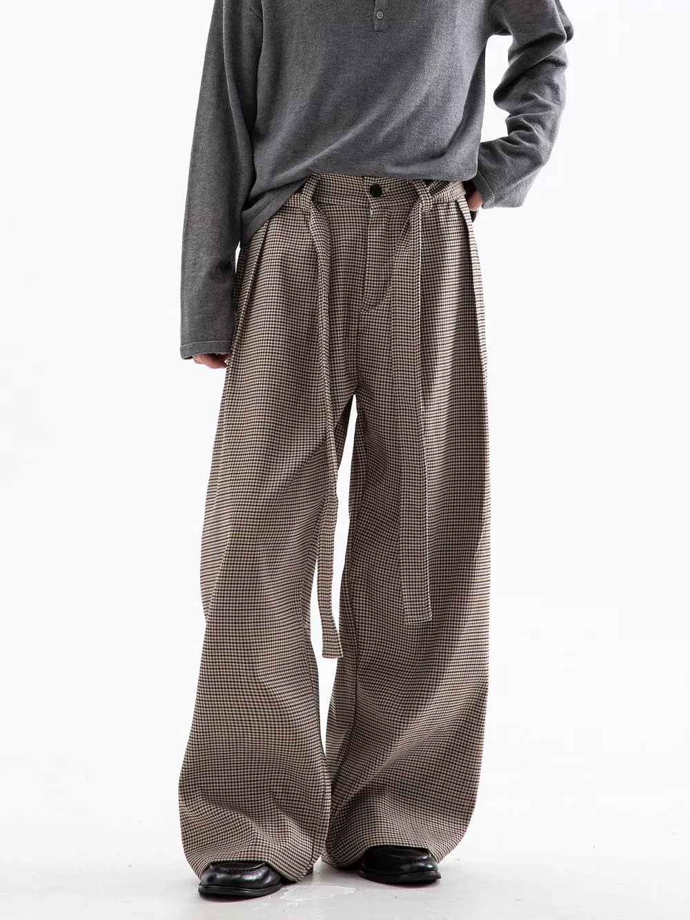 Men's wide leg check trousers in beige and brown with a belted waist.