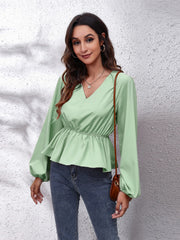 Light Green peplum blouse with V-neck, gathered waist, and balloon sleeves.