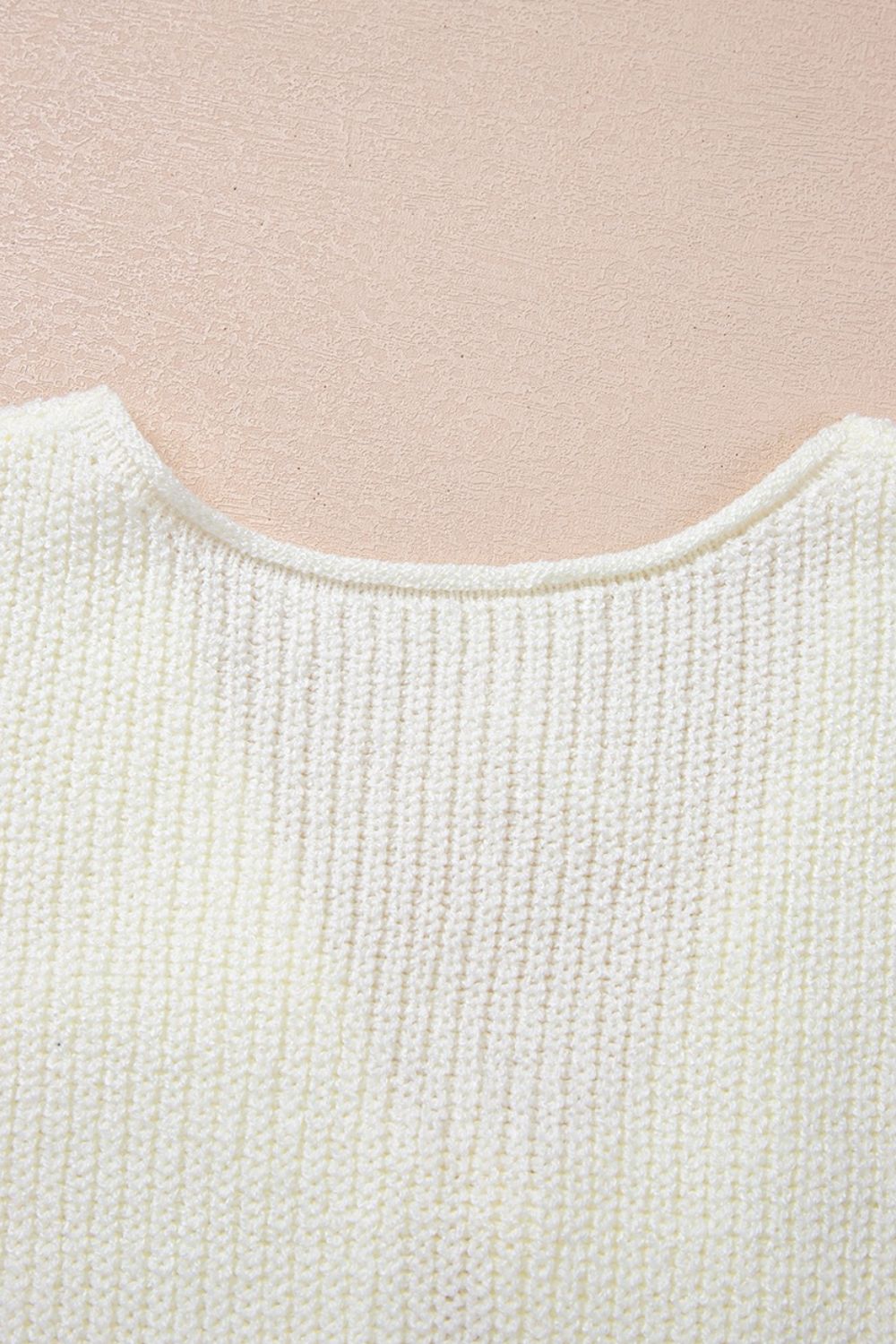 Cream textured knit tank top with a rounded neckline and ribbed detail.
