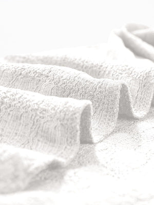White woven texture cap-sleeve top showing fabric detail