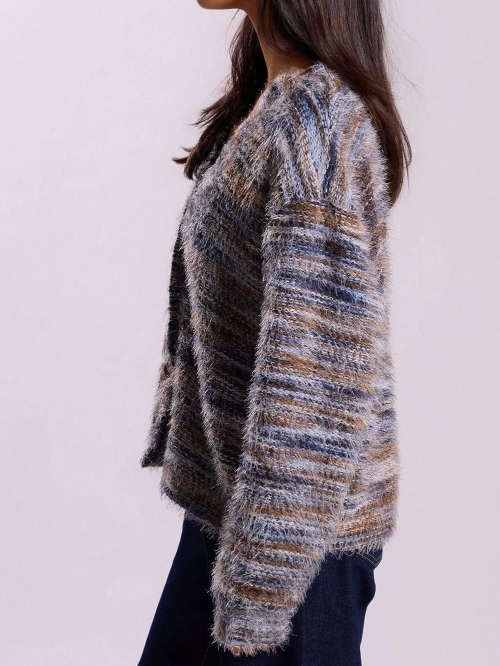 Cozy textured knit cardigan in a multi-color stripe pattern with fuzzy yarn and a relaxed fit.